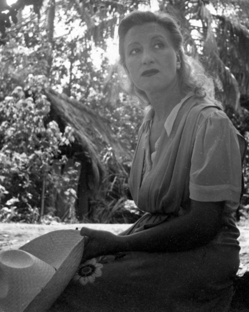 Esperanza Lopez Mateos sitting near a hut in Southern Mexico