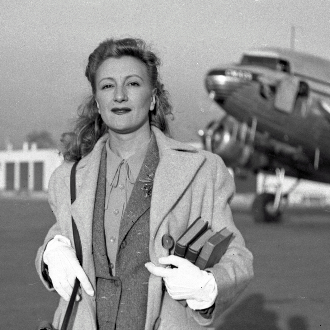 Esperanza Lopez Mateos at airport holding books