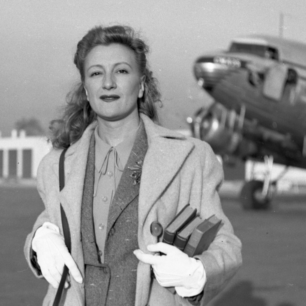 Esperanza Lopez Mateos at airport holding books