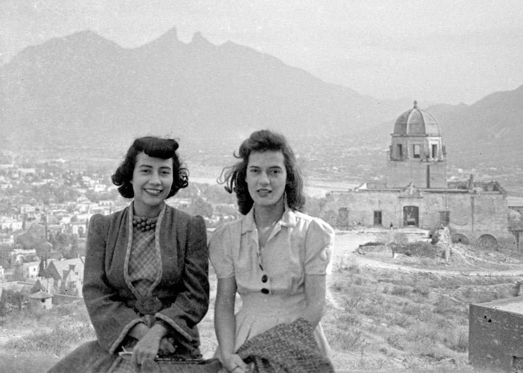 Two women in front of Saddleback Mountain overlooking the Palacio del Osbispado