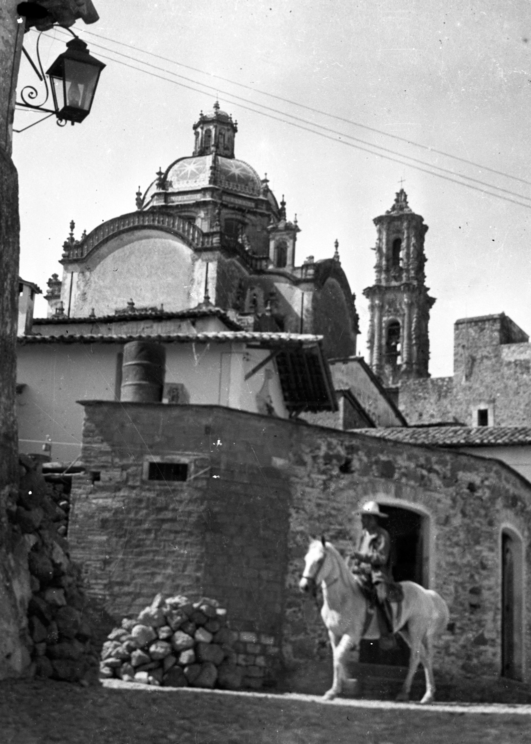 1940s man on horse in front of old church