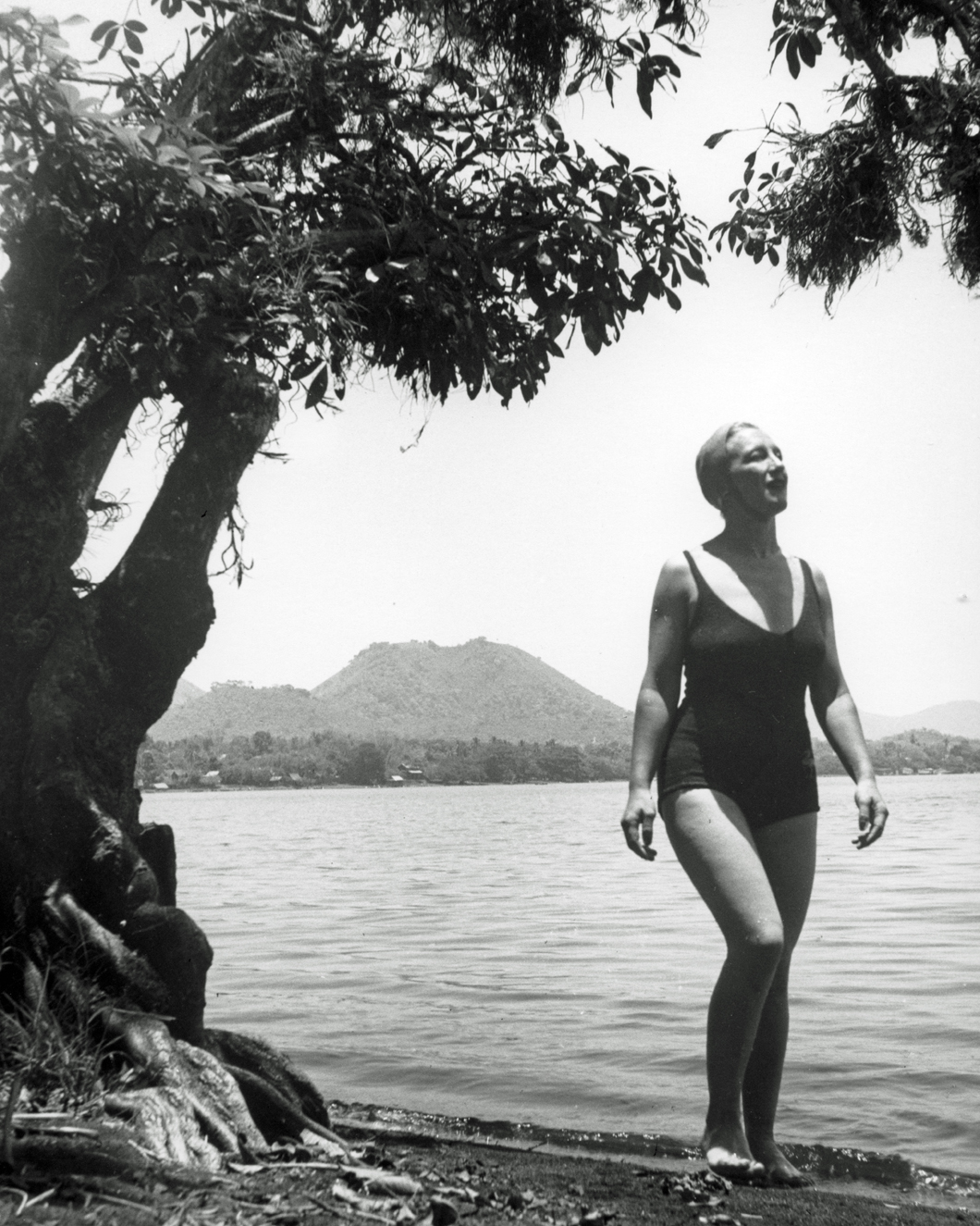 Esperanza in bathing suit standing in front of large lake