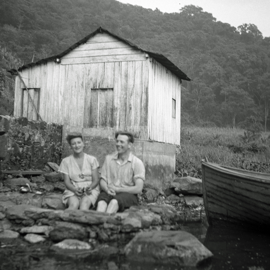 Esperanza and Henry Schnautz with feet in water lakeside